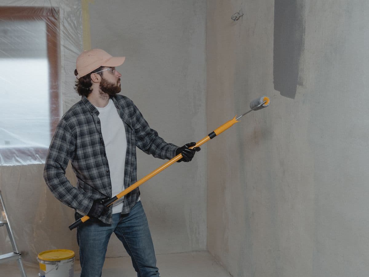 Painter using a roller during a room renovation