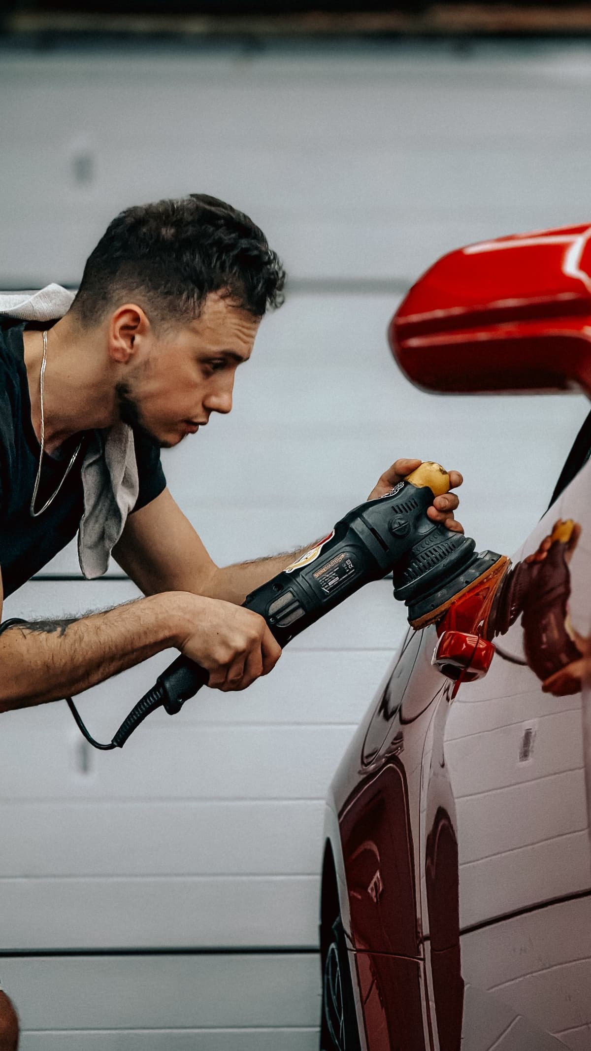 Professional detailer performing auto detailing on a real job