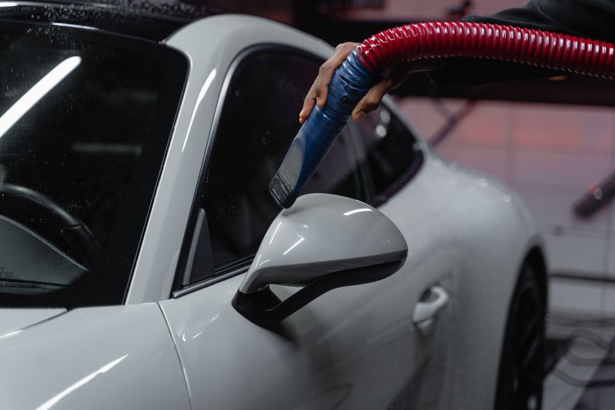 Professional detailer performing auto detailing on a real job