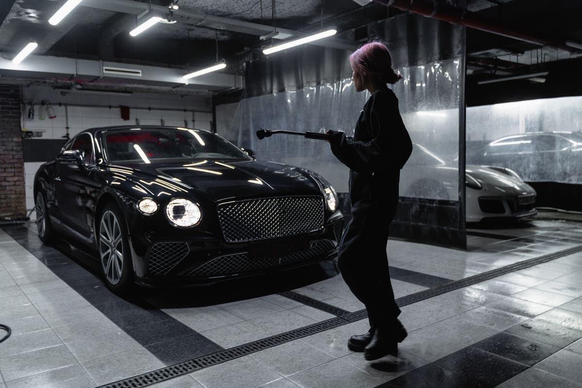 Professional detailer performing auto detailing on a real job