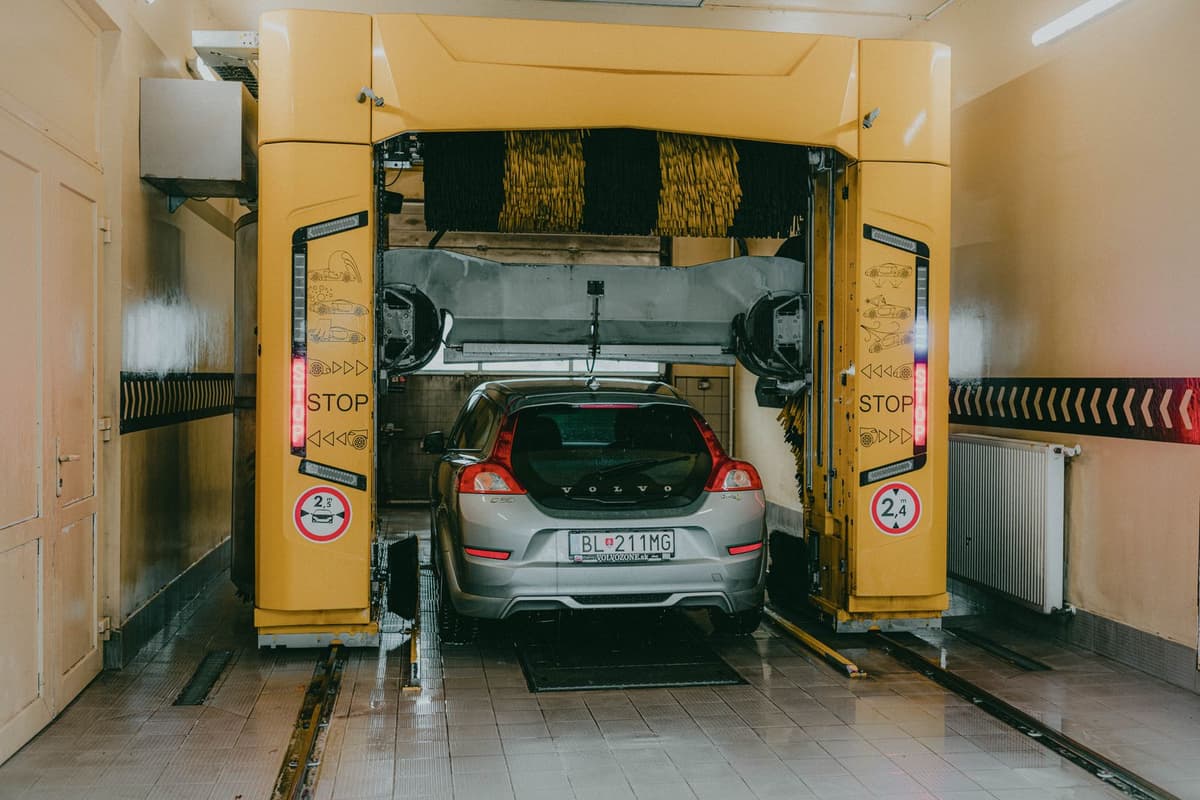 Professional car wash crew performing car washing on a real job