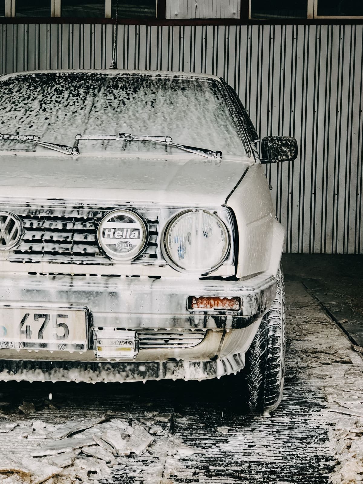 Professional car wash crew performing car washing on a real job