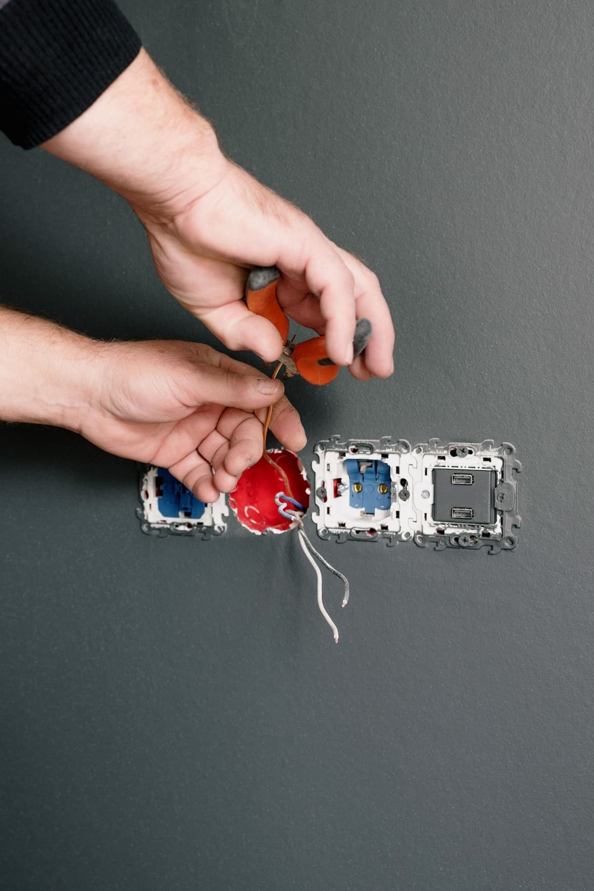 Professional electrician performing electrical work on a real job