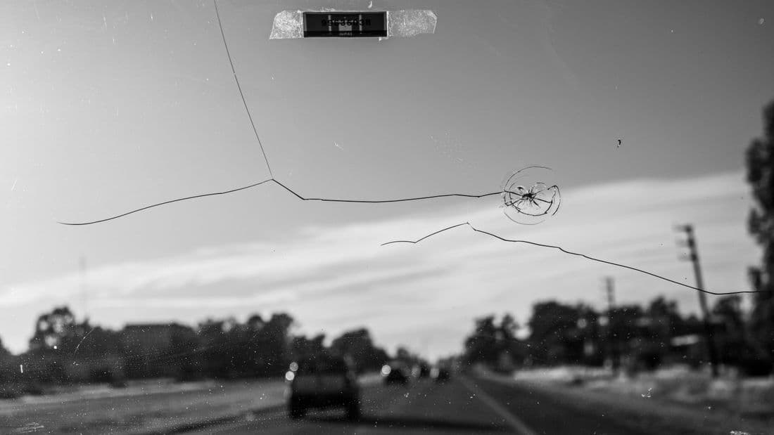 Cracked windshield on a car showing damage that needs repair