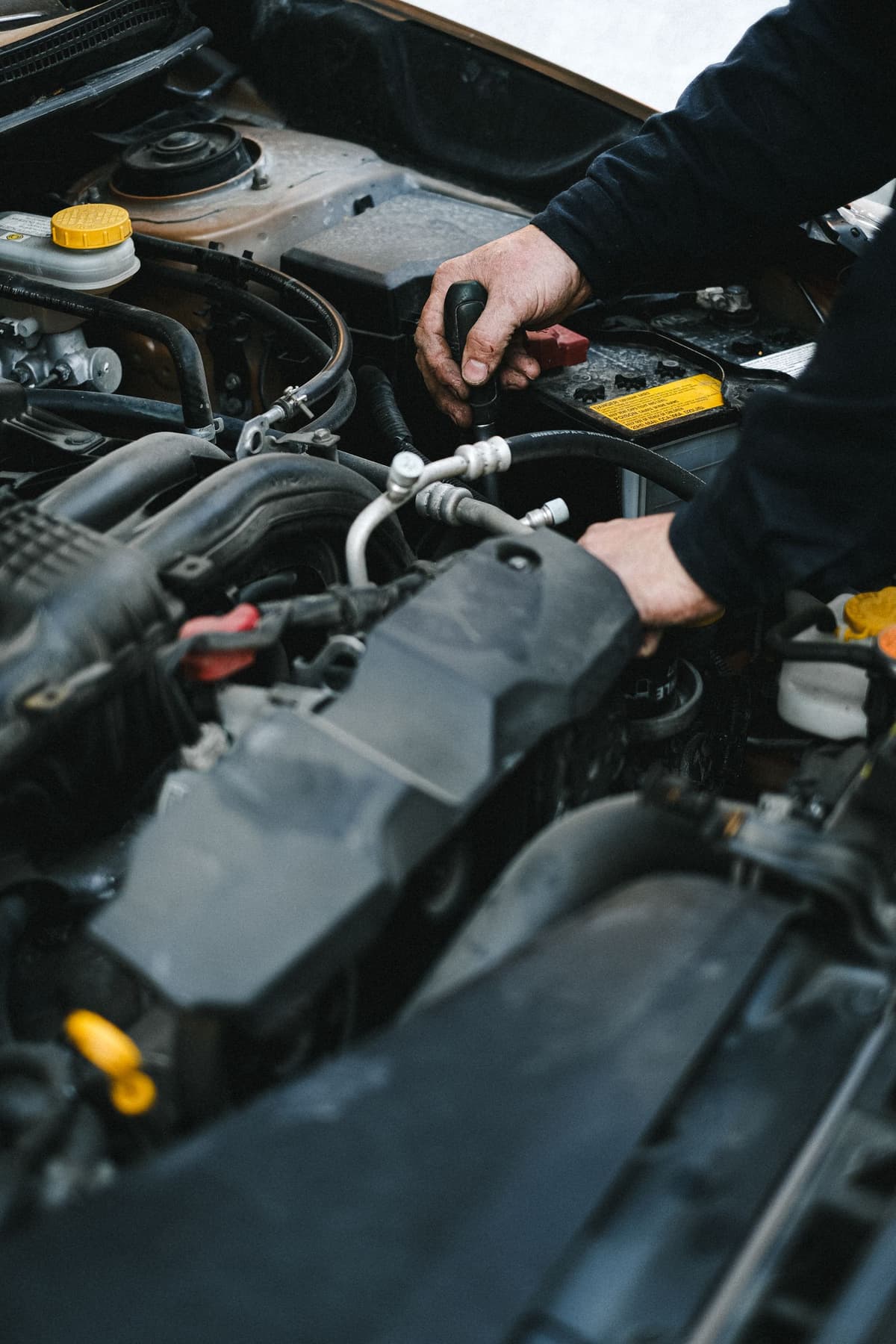 Professional mechanic performing auto repair on a real job