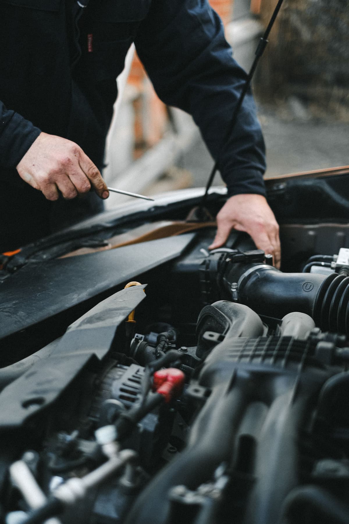 Professional mechanic performing auto repair on a real job