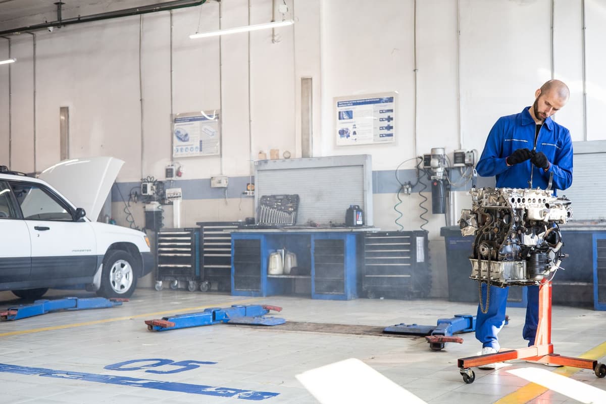 Professional mechanic performing auto repair on a real job