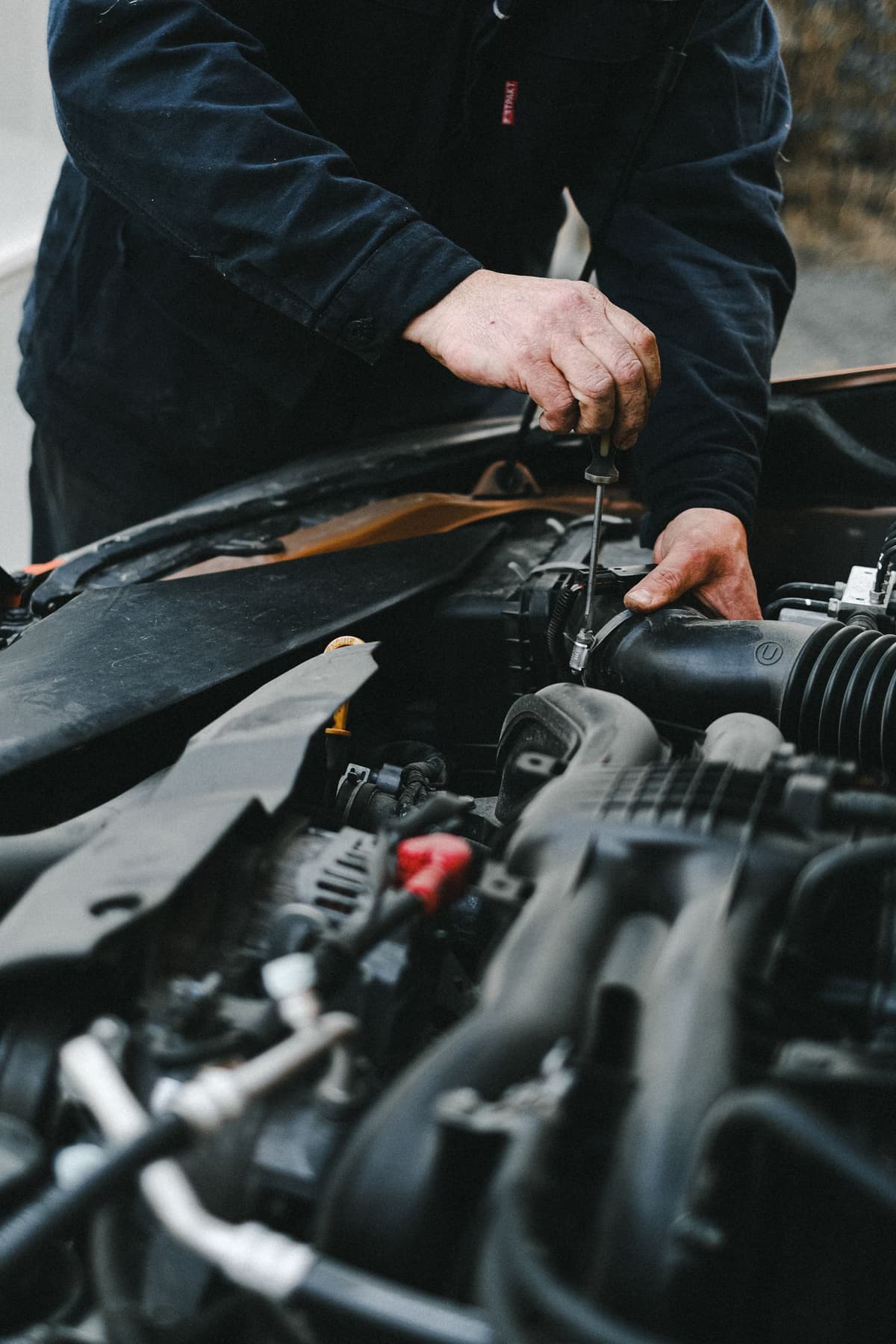 Professional mechanic performing auto repair on a real job