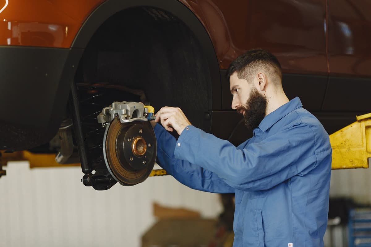 Professional mechanic performing auto repair on a real job