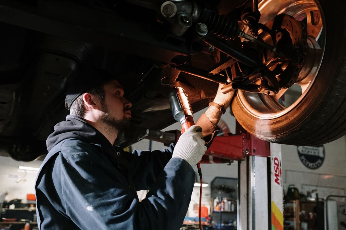 Professional mechanic performing auto repair on a real job