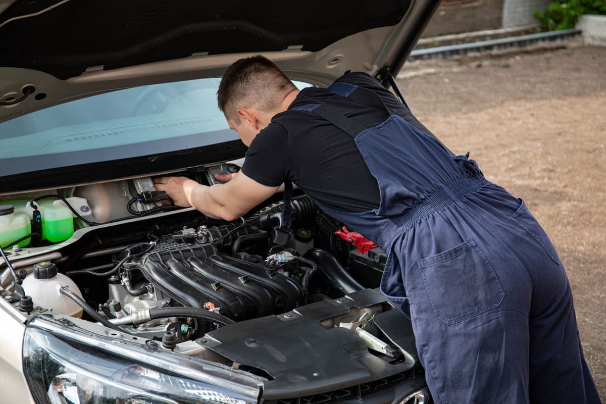 Professional mechanic performing auto repair on a real job