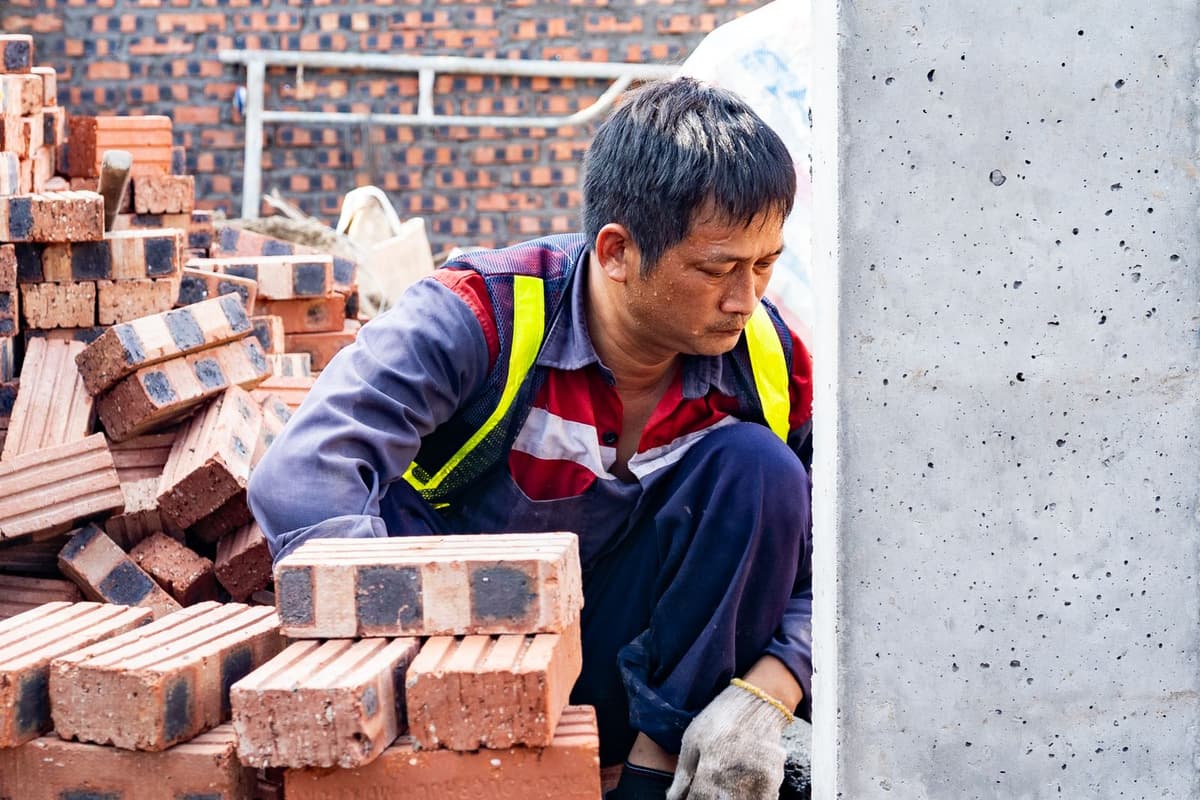 Professional concrete worker performing concrete and masonry work on a real job
