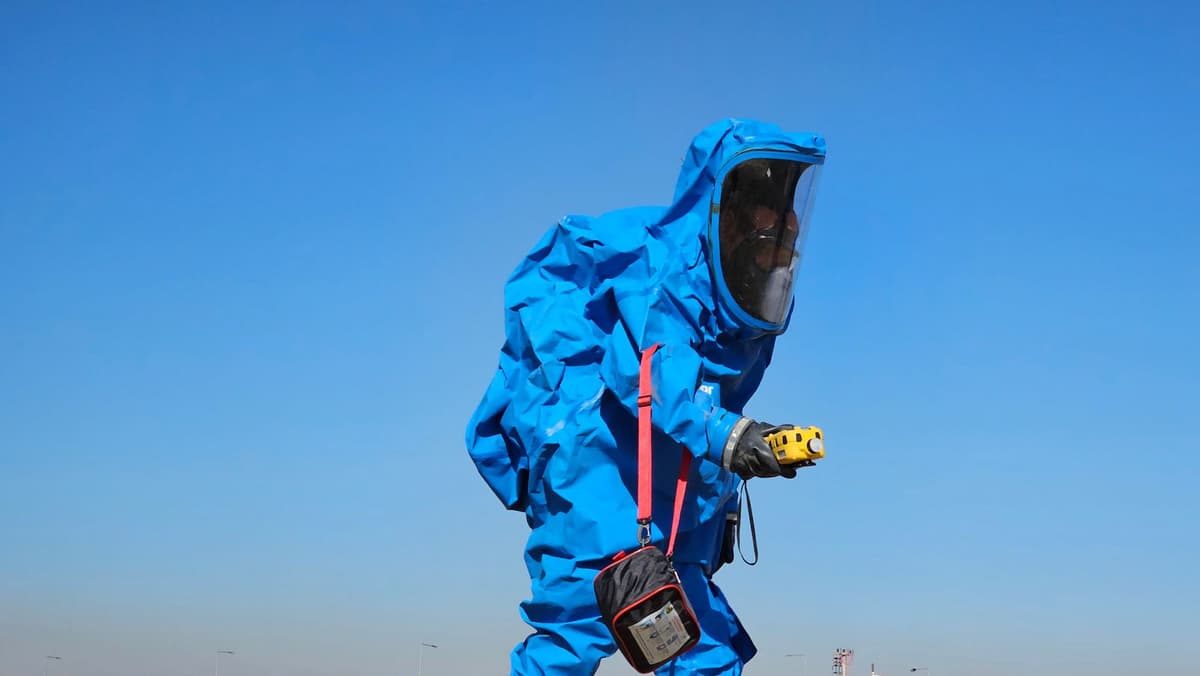 Professional pest control tech performing pest control service on a real job