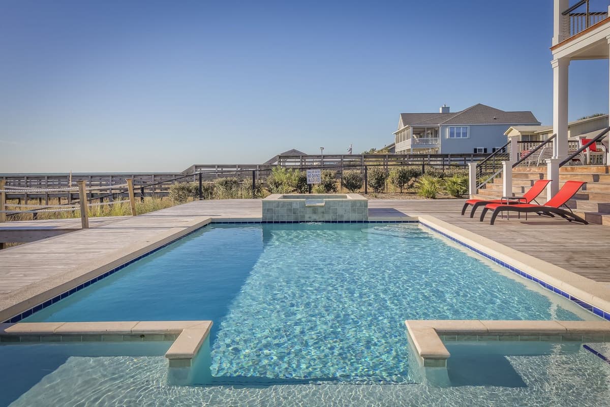 Professional pool technician performing pool maintenance on a real job