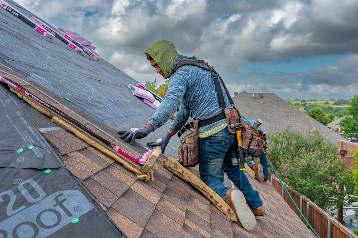 Professional roofer performing roofing work on a real job